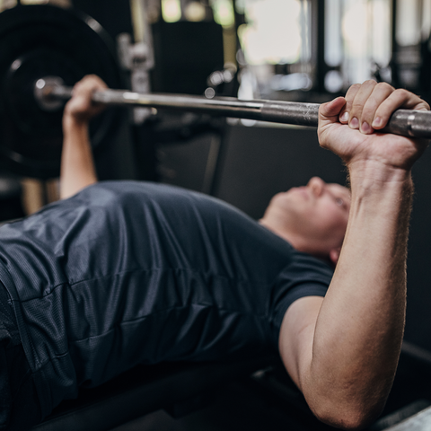 Man in gym lifting weights